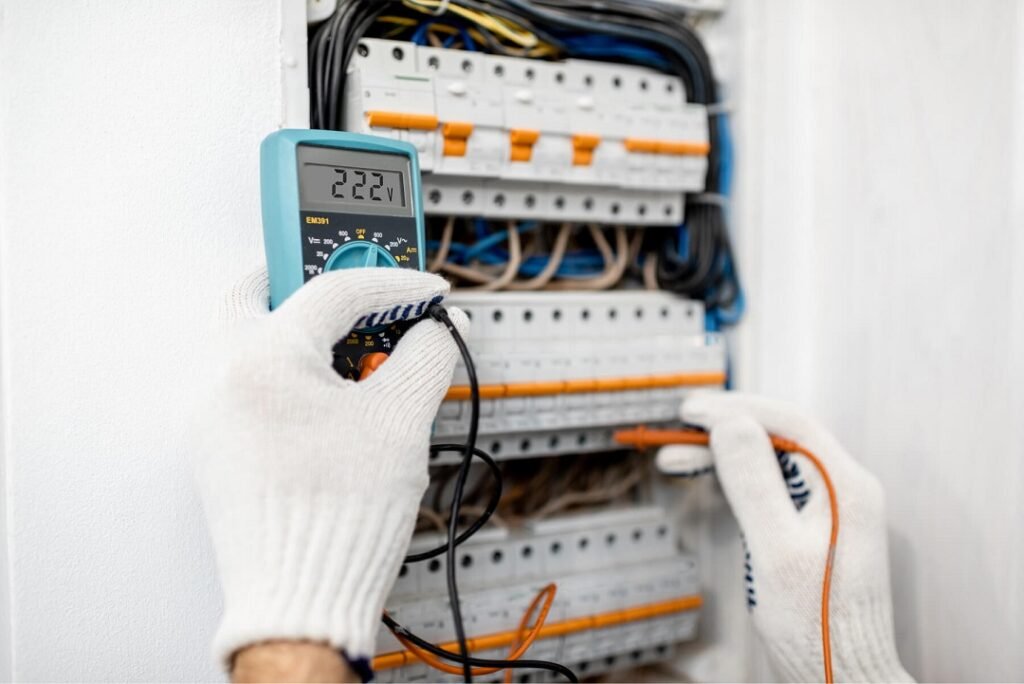 electrician testing electrical panel in il home