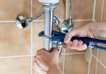 plumber repairing the bathroom plumbing in an arizona home